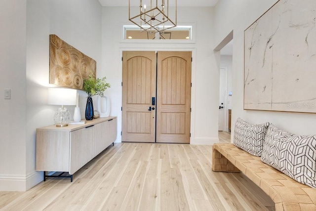 13791 Abberwick Dr, Orlando, FL 32832 - entrance foyer with light wood-style floors, a towering ceiling, baseboards, and a chandelier