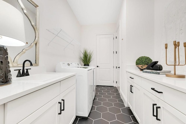 13791 Abberwick Dr, Orlando, FL 32832 - laundry room featuring washer and clothes dryer, cabinet space, and dark tile patterned flooring