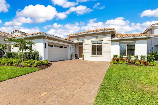 13791 Abberwick Dr, Orlando, FL 32832 - mediterranean / spanish-style house with stucco siding, an attached garage, decorative driveway, and a front lawn