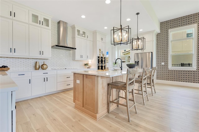 13791 Abberwick Dr, Orlando, FL 32832 - kitchen featuring wall chimney exhaust hood, wallpapered walls, stainless steel refrigerator with ice dispenser, light countertops, and a sink