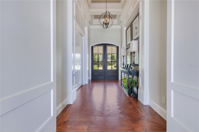 10845 Bayshore Dr, Windermere, FL 34786 - foyer featuring french doors, a chandelier, ornamental molding, baseboards, and arched walkways