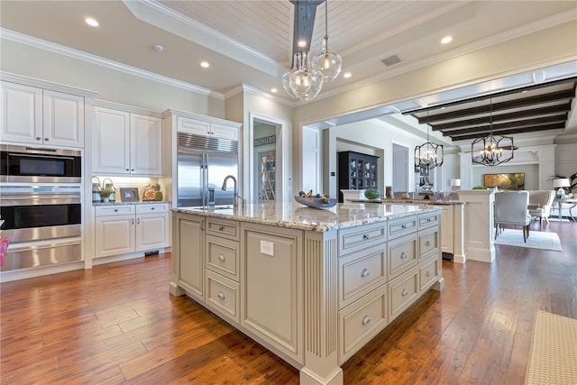 10845 Bayshore Dr, Windermere, FL 34786 - kitchen featuring a chandelier, a warming drawer, appliances with stainless steel finishes, open floor plan, and ornamental molding