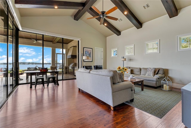 10845 Bayshore Dr, Windermere, FL 34786 - living room featuring a ceiling fan, beam ceiling, wood-type flooring, a water view, and baseboards