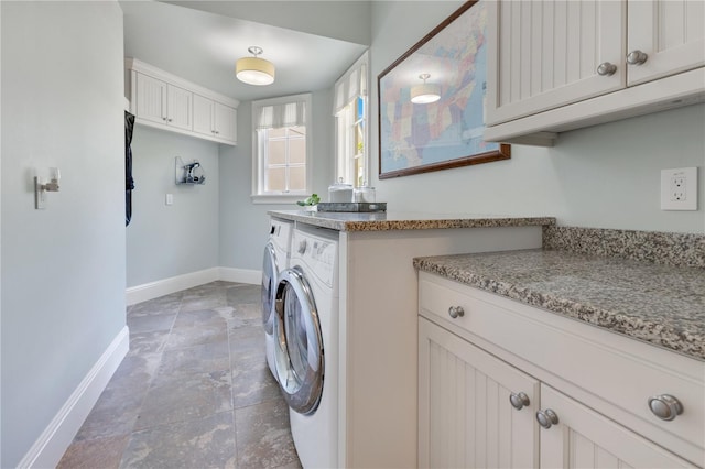 10845 Bayshore Dr, Windermere, FL 34786 - washroom with separate washer and dryer, baseboards, light stone finish floors, and cabinet space