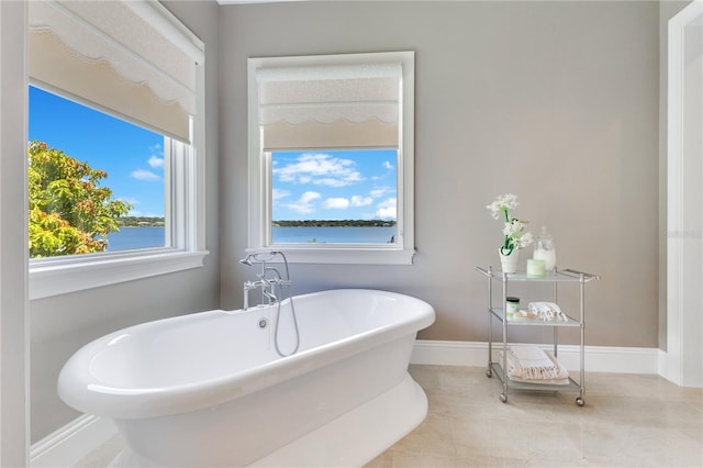 10845 Bayshore Dr, Windermere, FL 34786 - bathroom featuring a freestanding bath, baseboards, and tile patterned floors