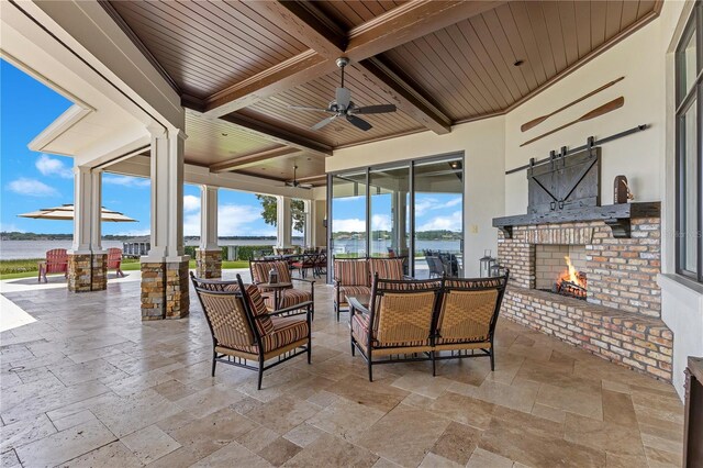 10845 Bayshore Dr, Windermere, FL 34786 - view of patio featuring an outdoor living space with a fireplace, a ceiling fan, a water view, and outdoor dining area