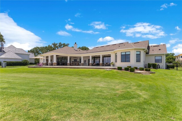 10845 Bayshore Dr, Windermere, FL 34786 - back of property featuring a chimney, stucco siding, a patio area, and central AC