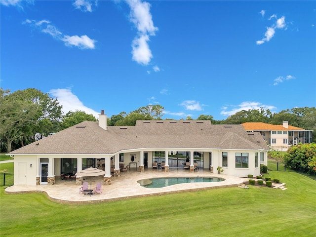 10845 Bayshore Dr, Windermere, FL 34786 - back of property featuring a patio, a chimney, roof with shingles, and an outdoor pool