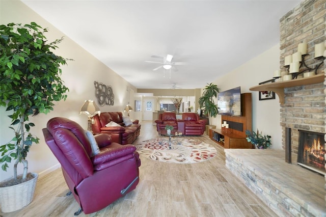 1074 Kensington Park Ct Unit 101, Altamonte Springs, FL 32714 - living area featuring wood finished floors, ceiling fan, and a brick fireplace