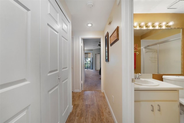 1074 Kensington Park Ct Unit 101, Altamonte Springs, FL 32714 - hallway with a sink, light wood-style flooring, baseboards, and recessed lighting