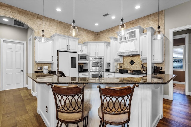190 Osprey Hammock Trl, Sanford, FL 32771 - kitchen with stainless steel appliances, dark wood finished floors, backsplash, baseboards, and white cabinets