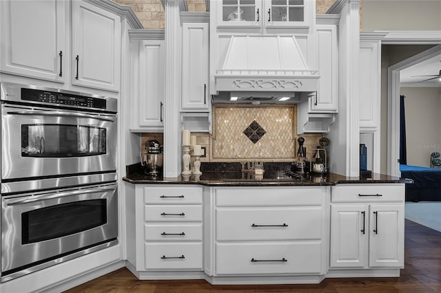 190 Osprey Hammock Trl, Sanford, FL 32771 - kitchen featuring double oven, black electric stovetop, white cabinets, backsplash, and dark stone counters