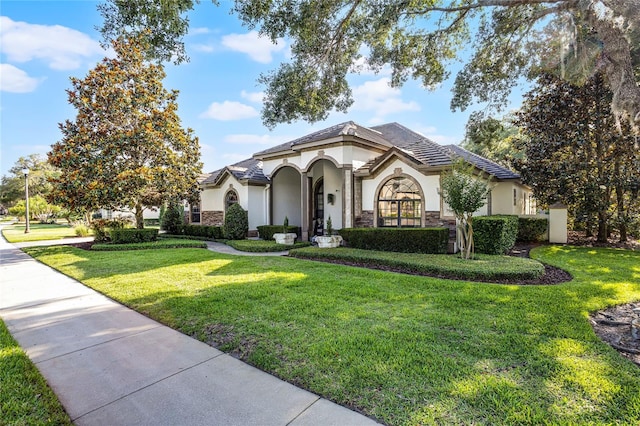 190 Osprey Hammock Trl, Sanford, FL 32771 - view of front of house featuring stucco siding, a front lawn, and stone siding