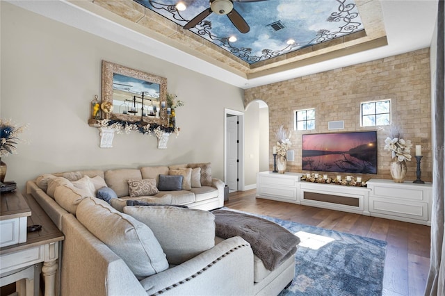 190 Osprey Hammock Trl, Sanford, FL 32771 - living room with a raised ceiling, arched walkways, ceiling fan, and hardwood / wood-style flooring