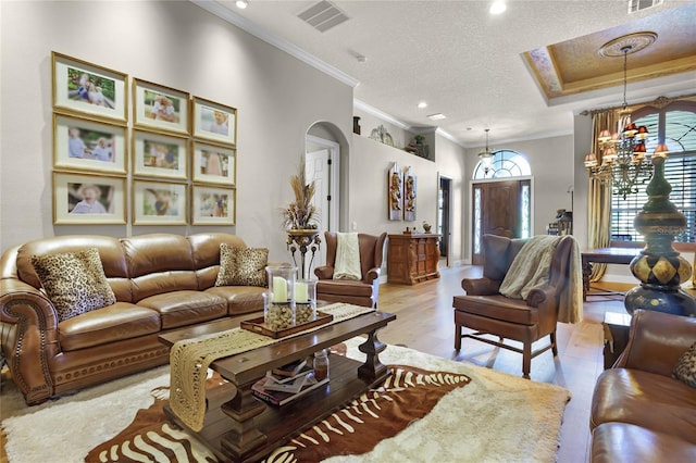 190 Osprey Hammock Trl, Sanford, FL 32771 - living area with crown molding, arched walkways, a textured ceiling, light wood finished floors, and a chandelier