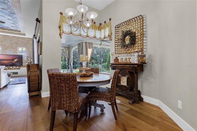 190 Osprey Hammock Trl, Sanford, FL 32771 - dining room featuring a chandelier, baseboards, wood finished floors, and vaulted ceiling