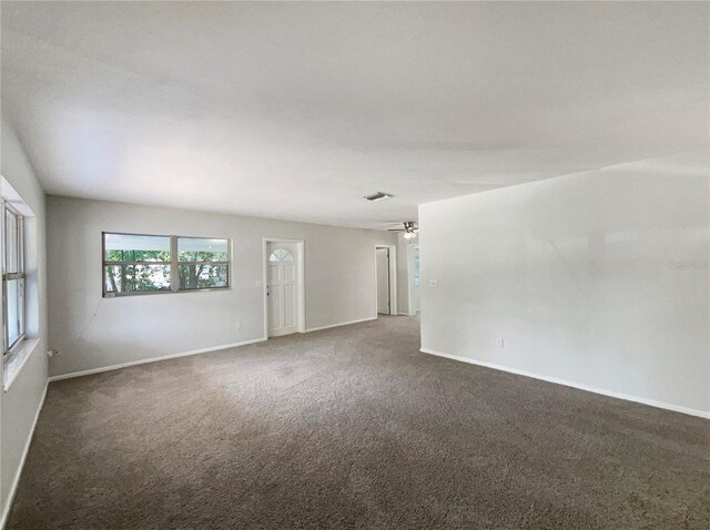 300 Ave E SE, Winter Haven, FL 33880 - unfurnished room with carpet floors, baseboards, and a ceiling fan