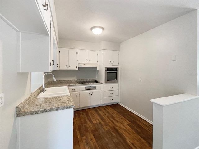 300 Ave E SE, Winter Haven, FL 33880 - kitchen with oven, a sink, under cabinet range hood, black electric cooktop, and dark wood-type flooring