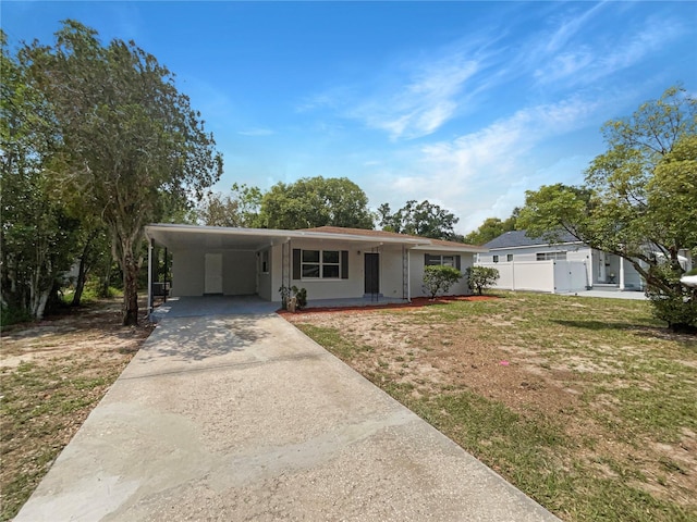 300 Ave E SE, Winter Haven, FL 33880 - view of front facade with driveway, a carport, and stucco siding