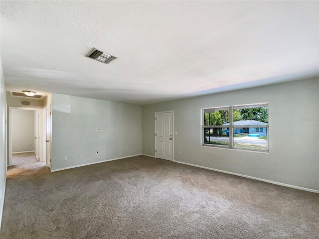 300 Ave E SE, Winter Haven, FL 33880 - empty room with carpet, baseboards, and a textured ceiling