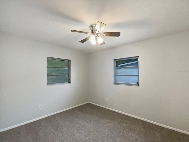 300 Ave E SE, Winter Haven, FL 33880 - spare room featuring dark colored carpet, ceiling fan, and baseboards
