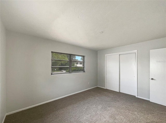 300 Ave E SE, Winter Haven, FL 33880 - unfurnished bedroom with a closet, carpet flooring, and baseboards