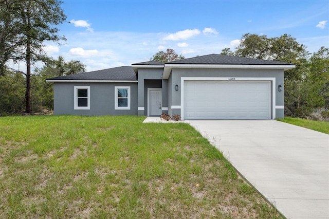16904 SW 30th Avenue Rd, Ocala, FL 34473 - view of front facade featuring stucco siding, a garage, a front lawn, and driveway