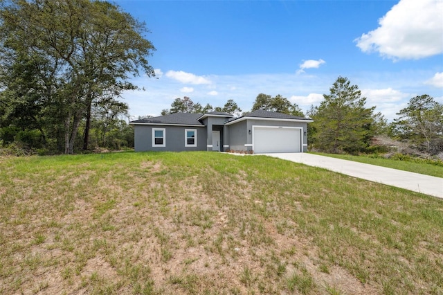 16904 SW 30th Avenue Rd, Ocala, FL 34473 - view of front of home featuring an attached garage, concrete driveway, a front lawn, and stucco siding