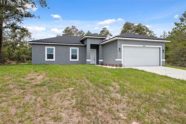 16904 SW 30th Avenue Rd, Ocala, FL 34473 - view of front facade featuring stucco siding, an attached garage, driveway, and a front yard
