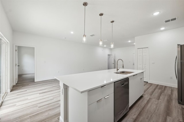 16904 SW 30th Avenue Rd, Ocala, FL 34473 - kitchen featuring stainless steel appliances, a sink, light wood-style floors, light countertops, and hanging light fixtures