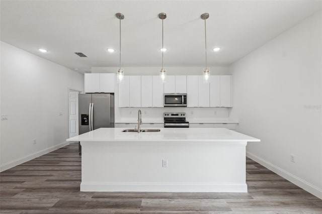16904 SW 30th Avenue Rd, Ocala, FL 34473 - kitchen with stainless steel appliances, a sink, an island with sink, white cabinets, and recessed lighting