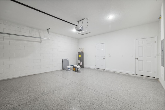 16904 SW 30th Avenue Rd, Ocala, FL 34473 - garage with electric water heater, a garage door opener, and concrete block wall
