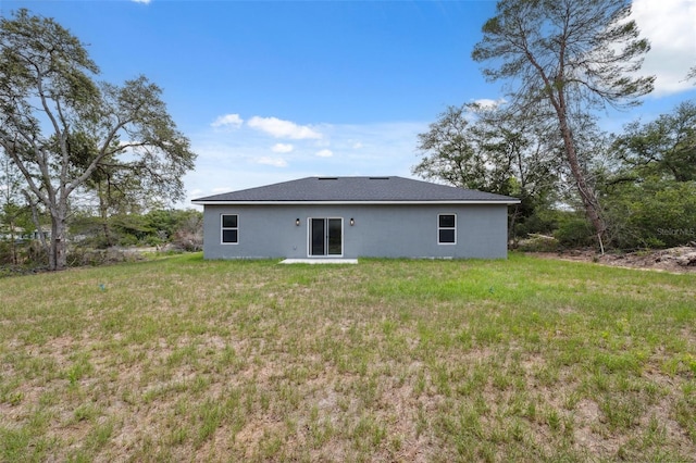 16904 SW 30th Avenue Rd, Ocala, FL 34473 - back of property with stucco siding and a lawn