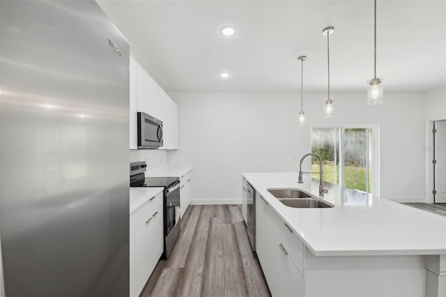 16904 SW 30th Avenue Rd, Ocala, FL 34473 - kitchen with appliances with stainless steel finishes, a sink, modern cabinets, wood finished floors, and recessed lighting