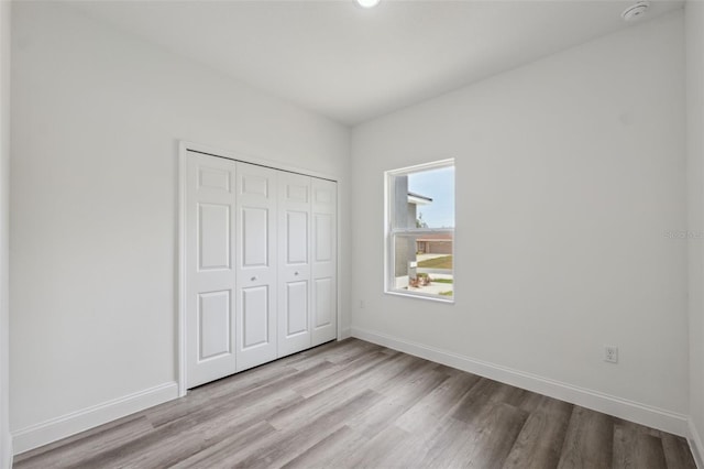 16904 SW 30th Avenue Rd, Ocala, FL 34473 - unfurnished bedroom featuring light wood-style flooring, baseboards, and a closet