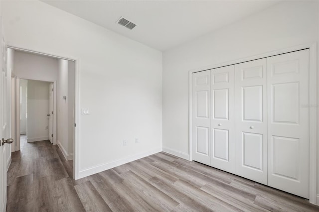 16904 SW 30th Avenue Rd, Ocala, FL 34473 - unfurnished bedroom with light wood-style floors, a closet, and baseboards