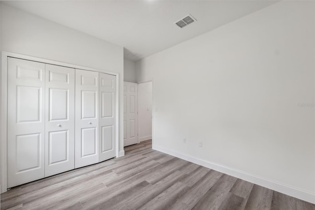 16904 SW 30th Avenue Rd, Ocala, FL 34473 - unfurnished bedroom featuring light wood-type flooring, a closet, and baseboards