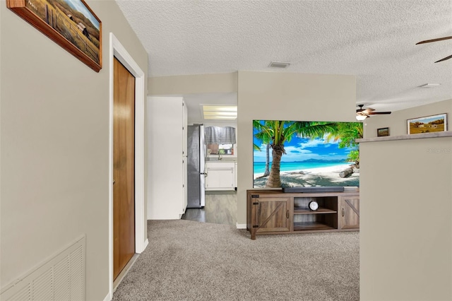 409 Jumper Dr S, Bushnell, FL 33513 - carpeted living area with ceiling fan and a textured ceiling