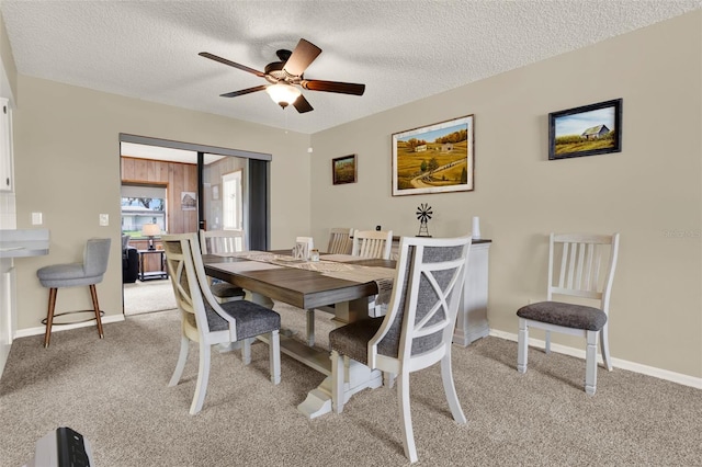 409 Jumper Dr S, Bushnell, FL 33513 - dining space featuring light carpet, ceiling fan, a textured ceiling, and baseboards
