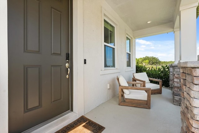5700 Iron Brand Rd, Saint Cloud, FL 34771 - view of exterior entry featuring covered porch and stucco siding