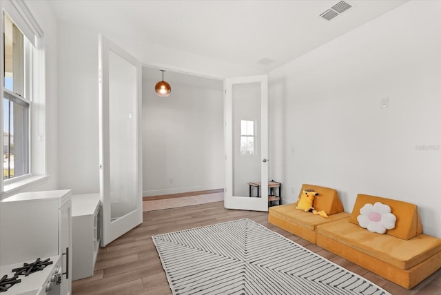 5700 Iron Brand Rd, Saint Cloud, FL 34771 - sitting room featuring light wood-type flooring, french doors, and baseboards