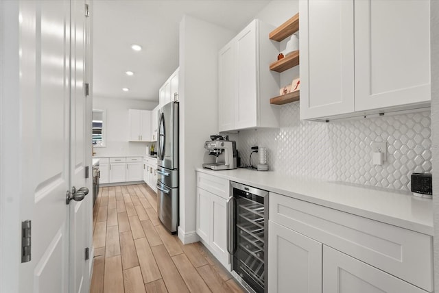 5700 Iron Brand Rd, Saint Cloud, FL 34771 - kitchen featuring beverage cooler, freestanding refrigerator, white cabinetry, open shelves, and light wood-style floors