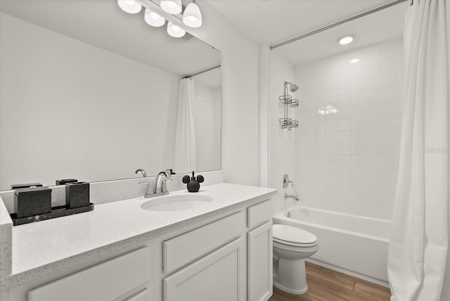 5700 Iron Brand Rd, Saint Cloud, FL 34771 - full bathroom featuring toilet, vanity, shower / bathtub combination with curtain, and wood finished floors