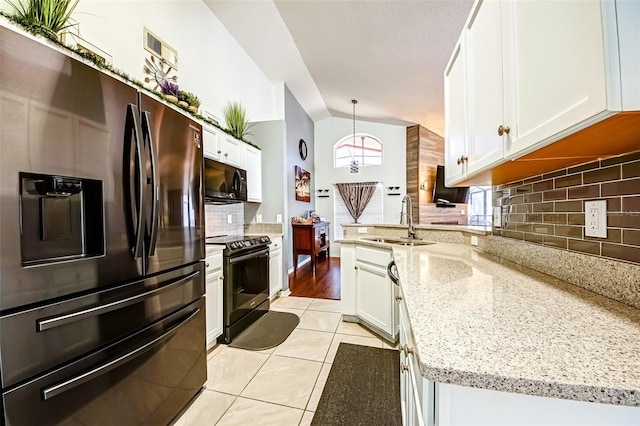 156 Carrera Ave, Davenport, FL 33897 - kitchen featuring black appliances, a sink, decorative backsplash, a peninsula, and white cabinetry