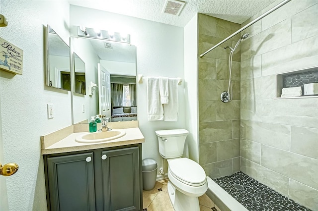 156 Carrera Ave, Davenport, FL 33897 - full bathroom with toilet, vanity, tiled shower, a textured ceiling, and tile patterned floors