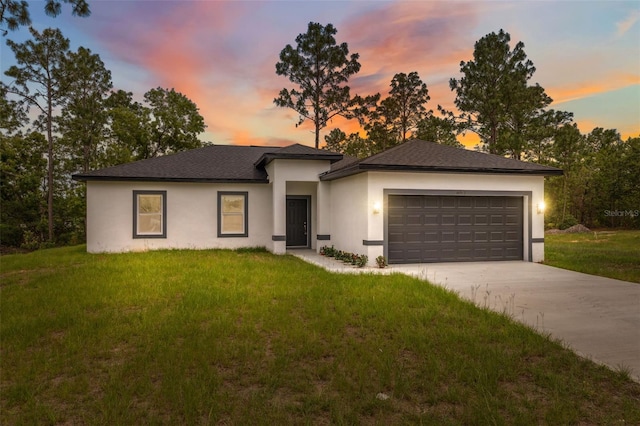 6062 SW 154th Pl, Ocala, FL 34473 - prairie-style house featuring a garage, stucco siding, a front yard, and driveway