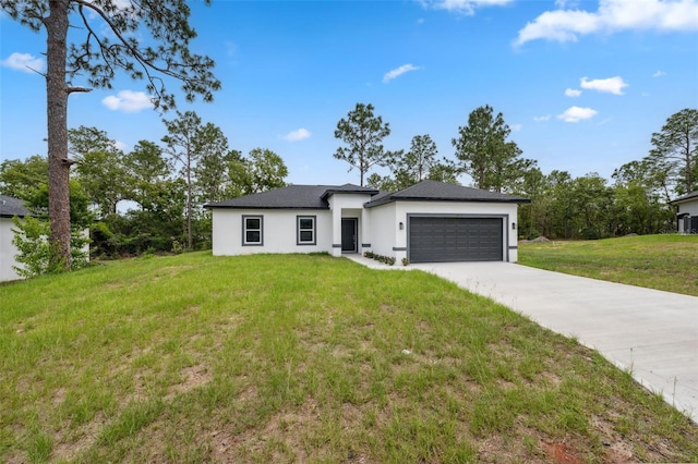 6062 SW 154th Pl, Ocala, FL 34473 - view of front of home with stucco siding, a garage, a front yard, and driveway