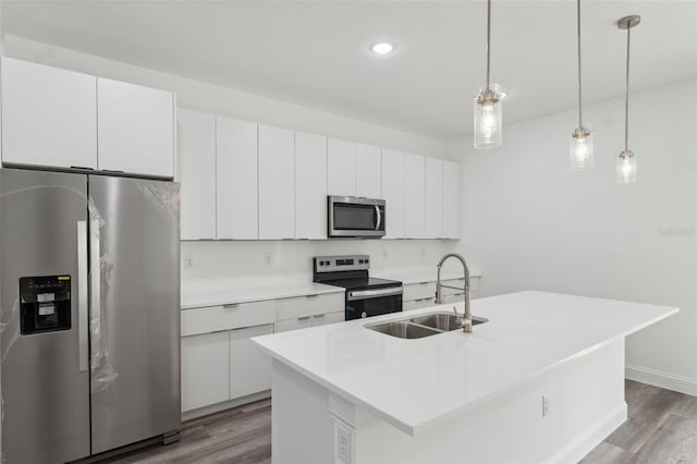 6062 SW 154th Pl, Ocala, FL 34473 - kitchen featuring appliances with stainless steel finishes, a sink, wood finished floors, white cabinetry, and recessed lighting