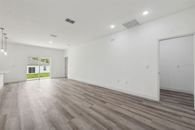 6062 SW 154th Pl, Ocala, FL 34473 - unfurnished living room featuring wood finished floors, recessed lighting, and baseboards