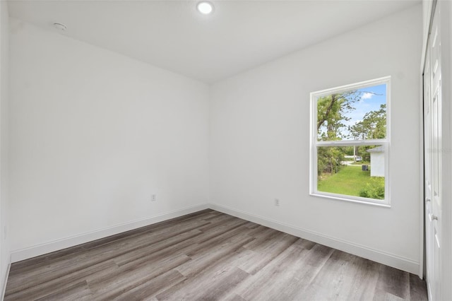 6062 SW 154th Pl, Ocala, FL 34473 - unfurnished room with wood finished floors, baseboards, and recessed lighting